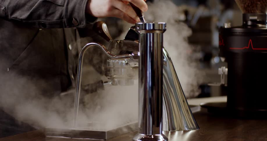 Steam rises from an espresso machine