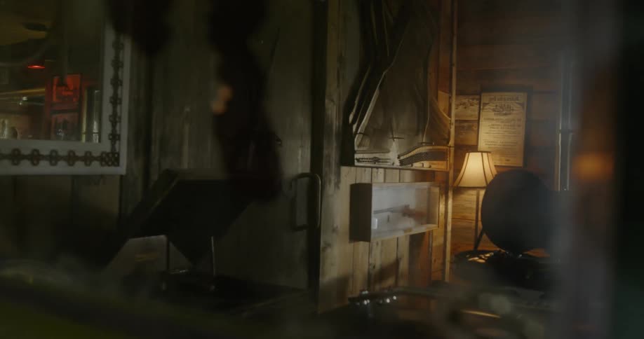 A lamp is on inside a storage area full of memorabilia