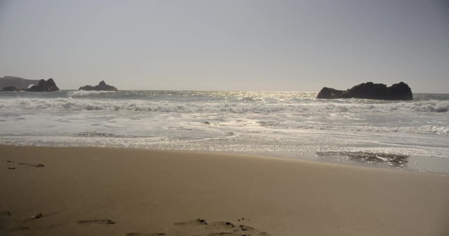 Waves flow onto the beach shore