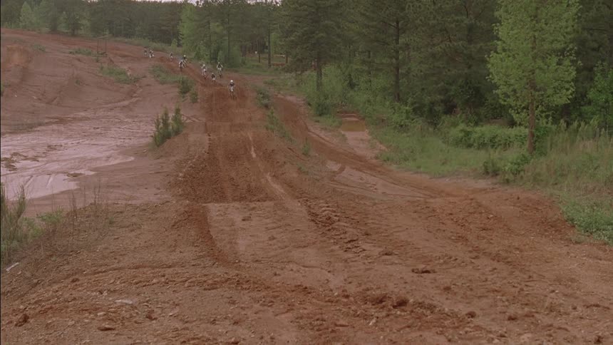 Dirt bikes racing down a path