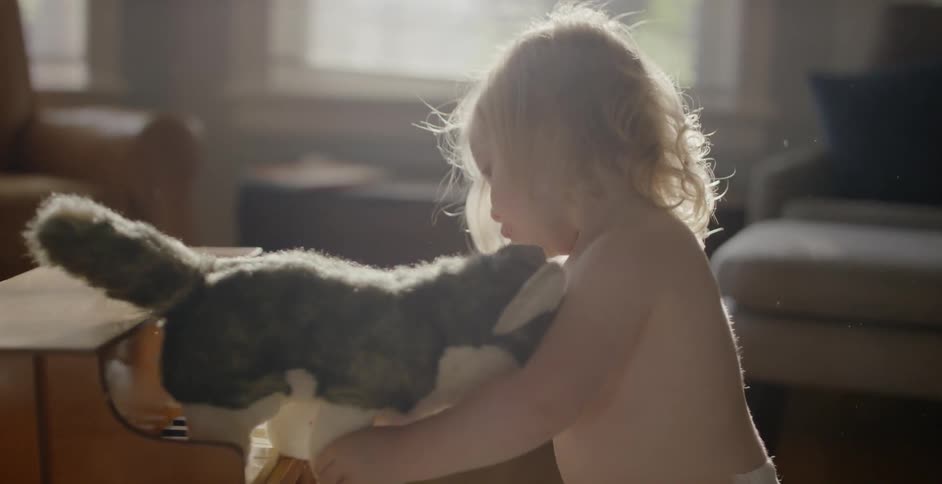 A child plays with her stuffed animal