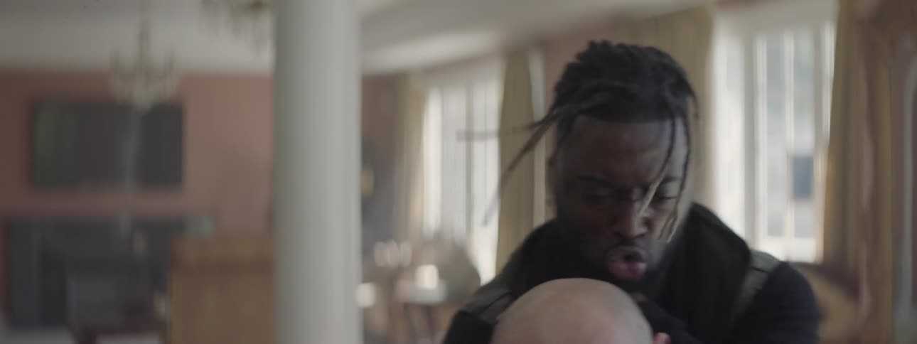 Two men fist fight in a house