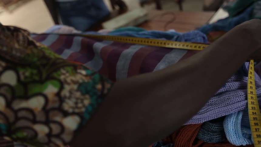 A person measuring fabric