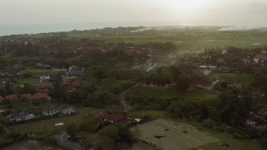 The long fields are full of trees and homes