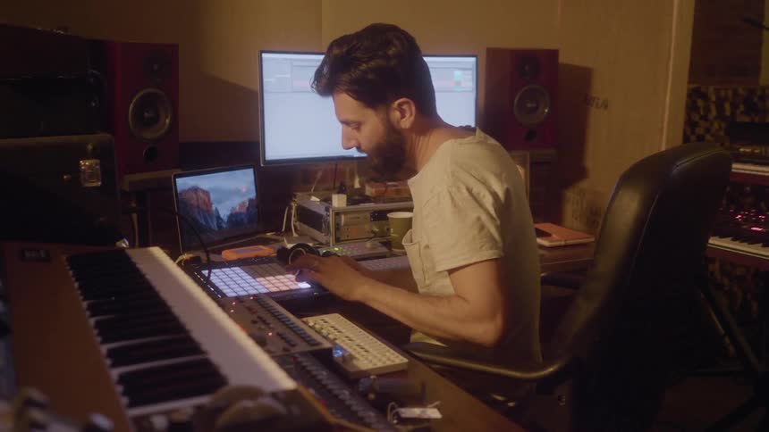 A man records music in a studio