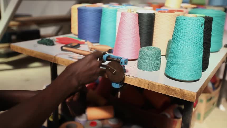 A person winding some thread