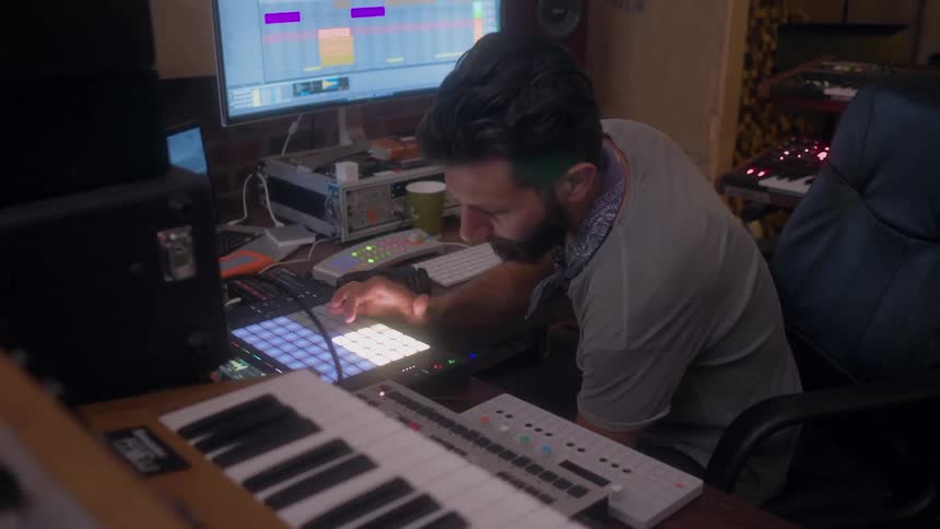 A man is playing music in his studio