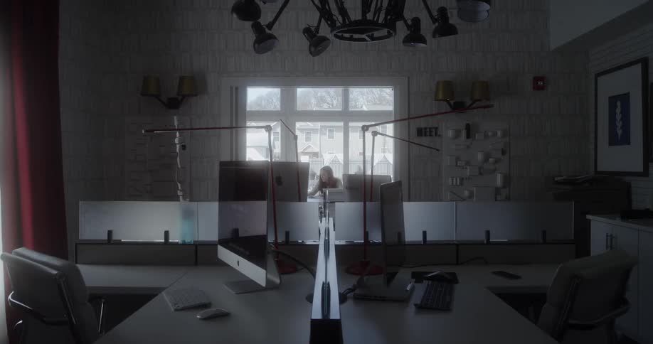 Woman sits in empty office working