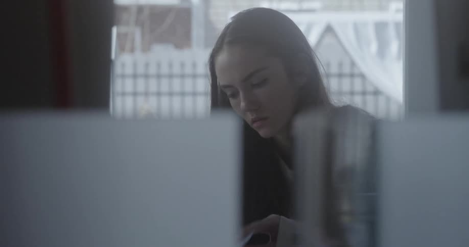 A girl flips through a notebook