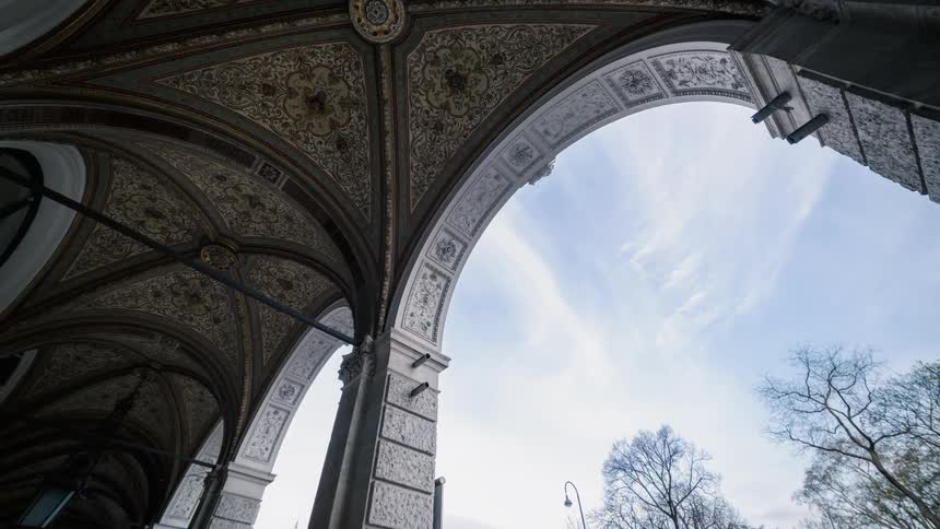 The clouds move fast over the arches of the building