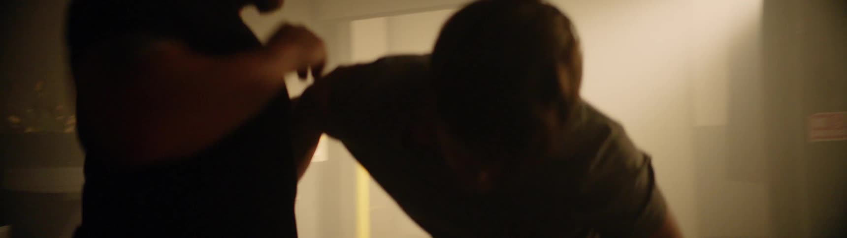 Two people are fighting in a bar