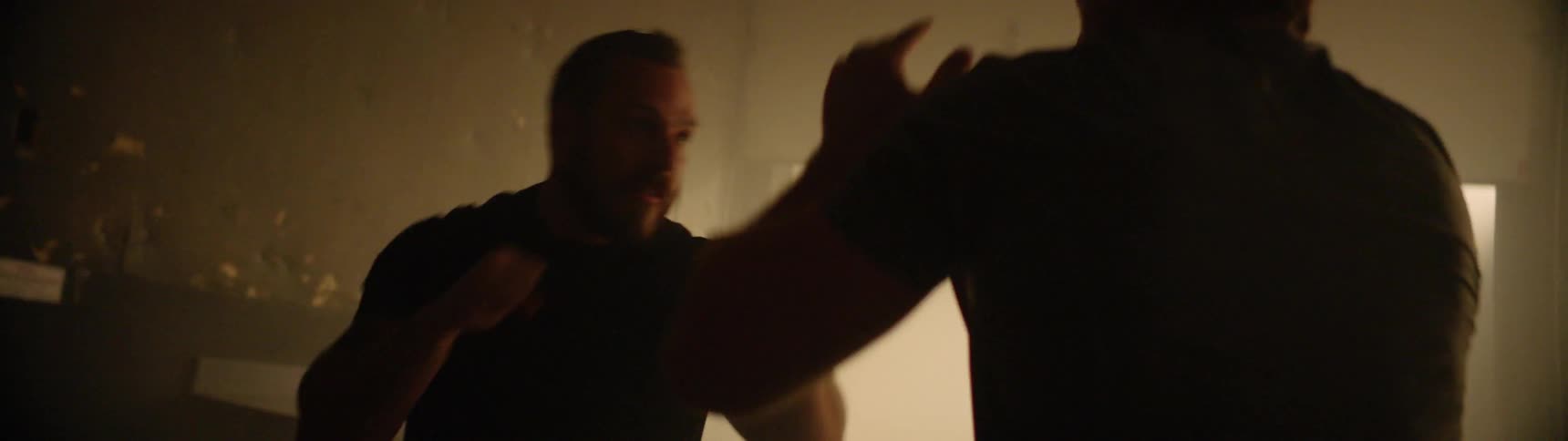 Two people are sparring each other in a gym