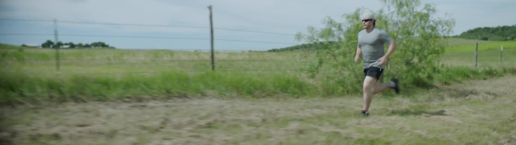 A man is running in the grass