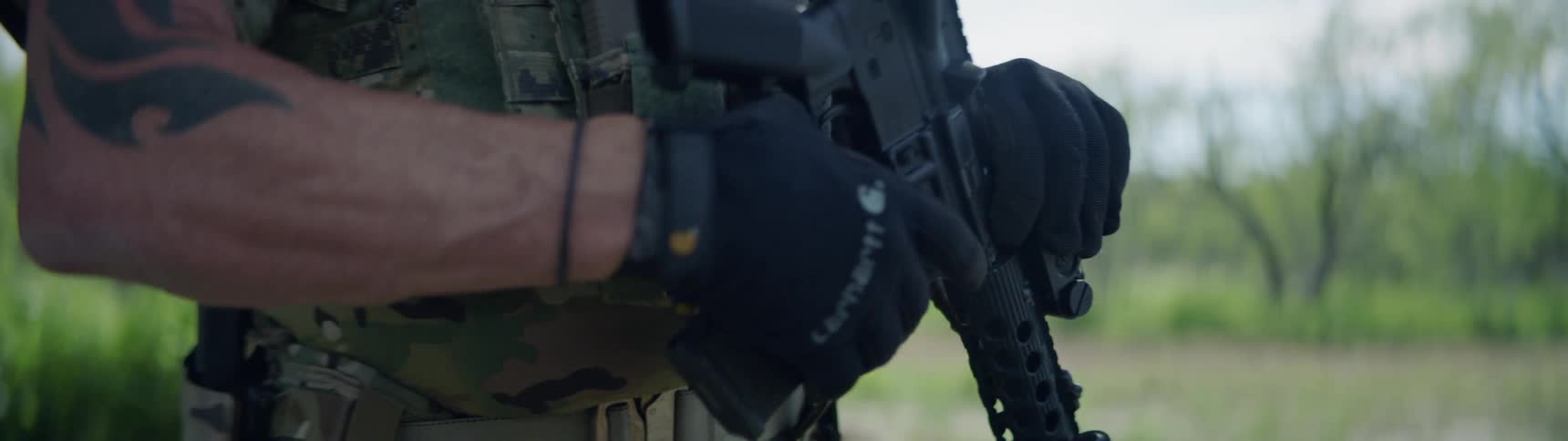 A soldier is putting the magazine into his gun