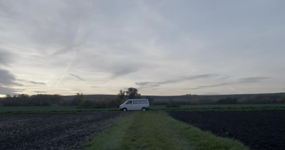 Small van passing some farmlands