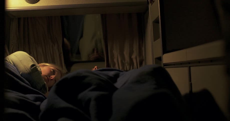 A man and woman lay in the back of a van