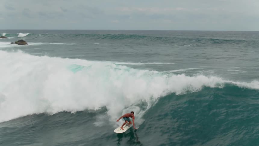 A surfer rides an ocean wave