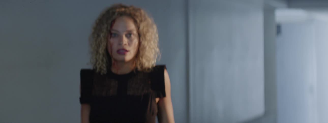 A bleeding woman is startled and backs away