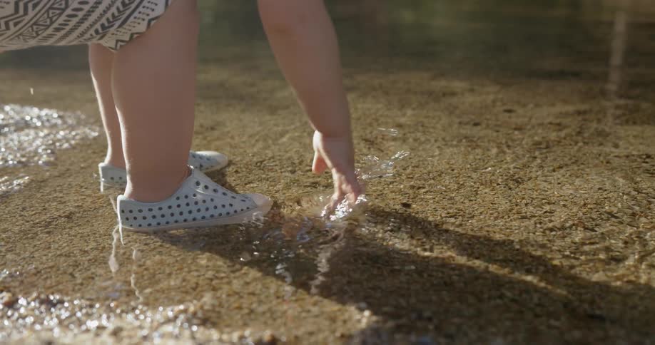 A young girl splashes in the water