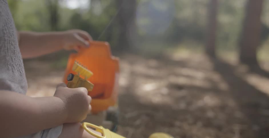 A child is playing with toys in the woods