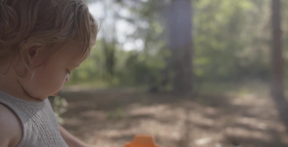 A baby is playing in the forest