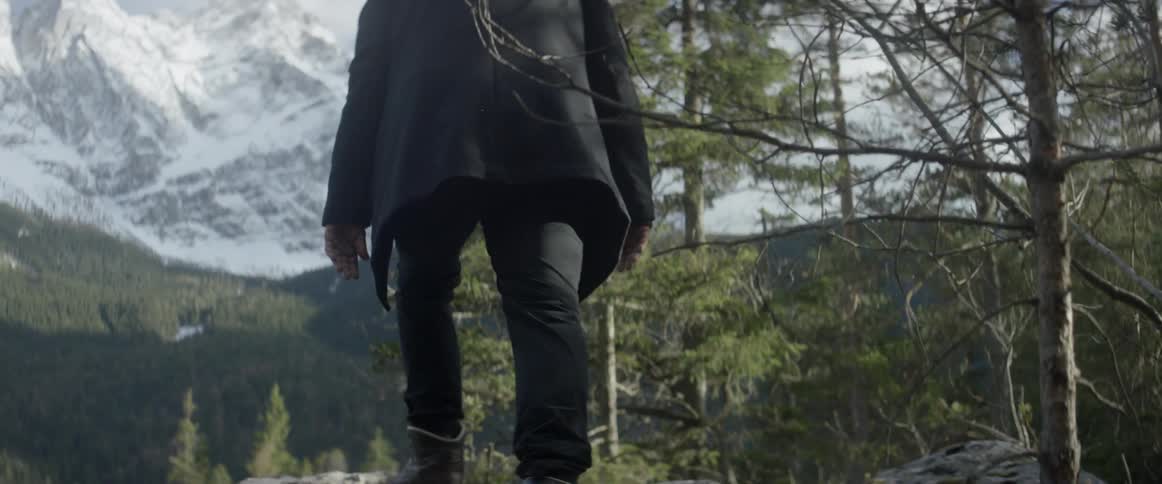 A man hikes up a rock