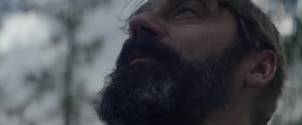 A man looks around on a cloudy day