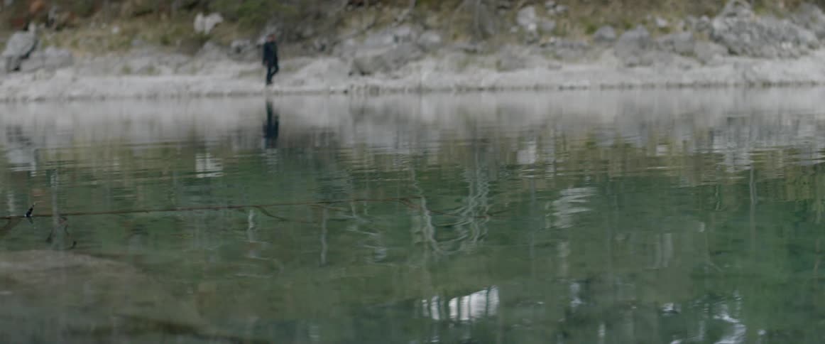 A man walks by the water