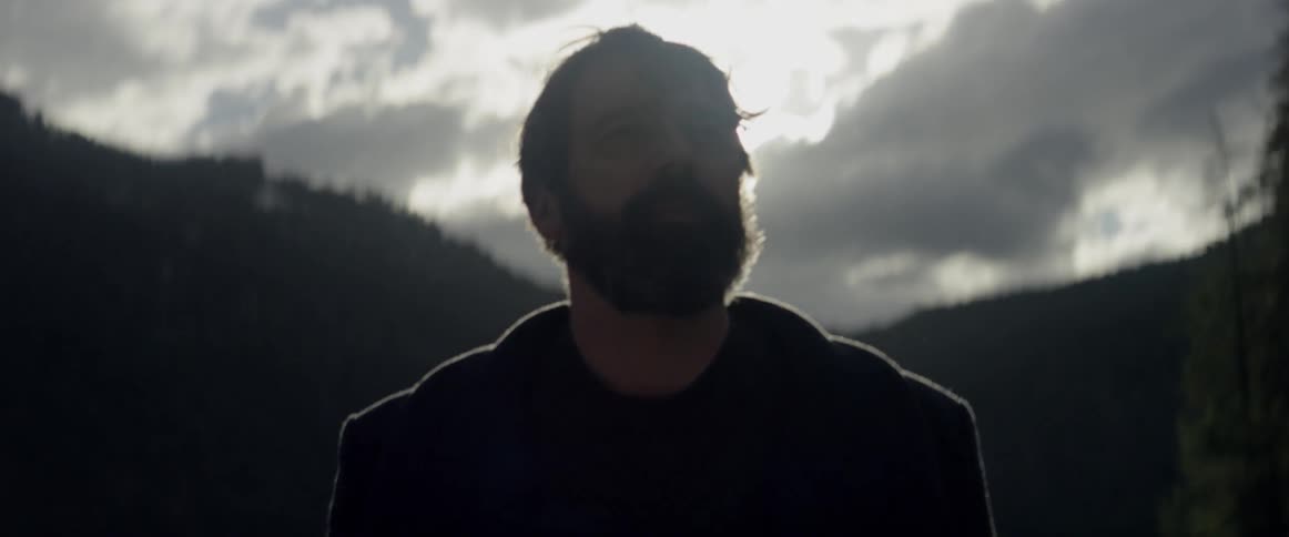 A man hikes outside on a cloudy day