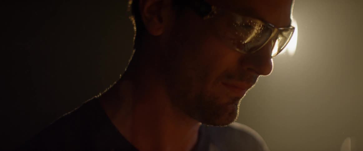 A man wears goggles as he welds
