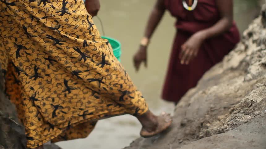 People passing a bucket of water