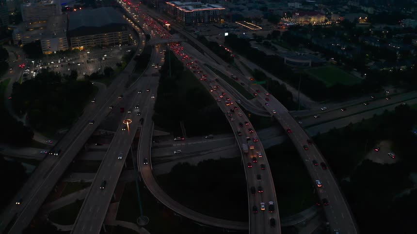 Vehicles travel on highway roads at night