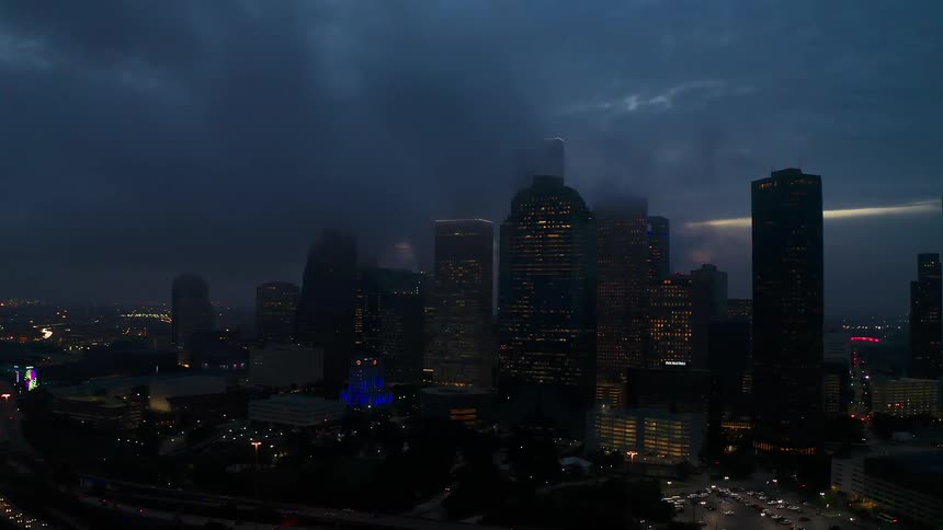 Clouds hang over a city at night
