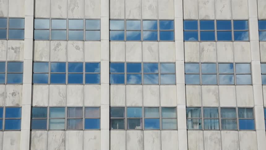 Trees stand outside a tall building