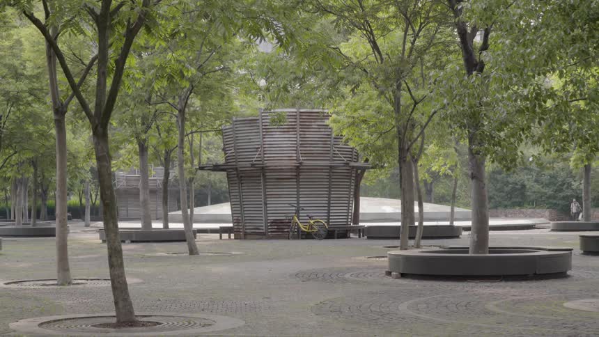 A bike is parked by a bench in a courtyard