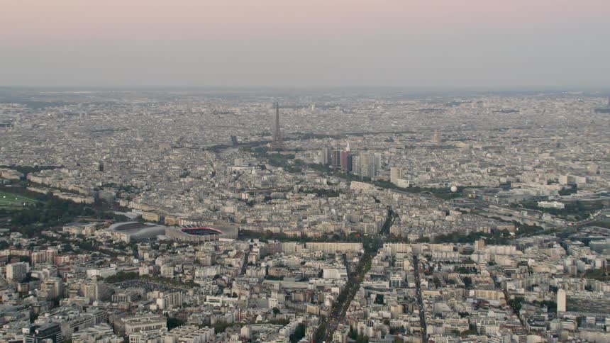 The eiffel tower dominates the skyline in a city on a smoggy day