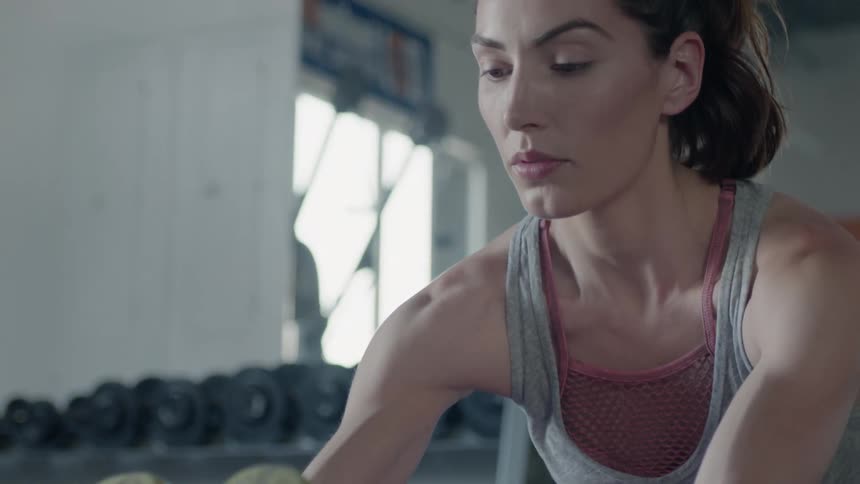A woman stretches in a gym
