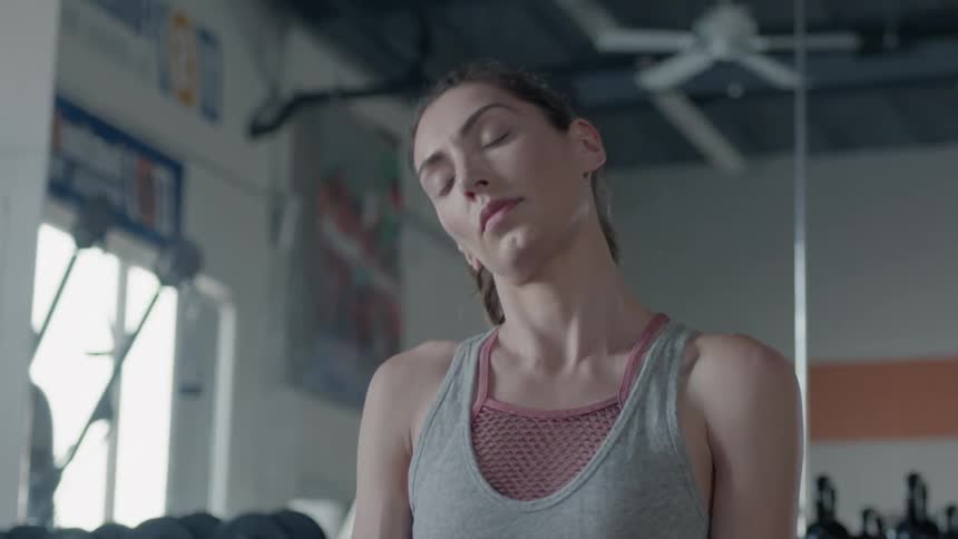 A woman stretches in a gym