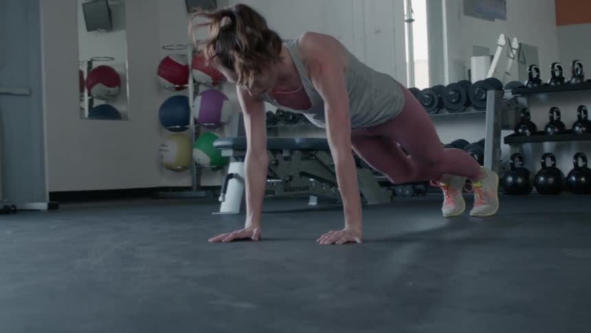 A woman exercises in a gym