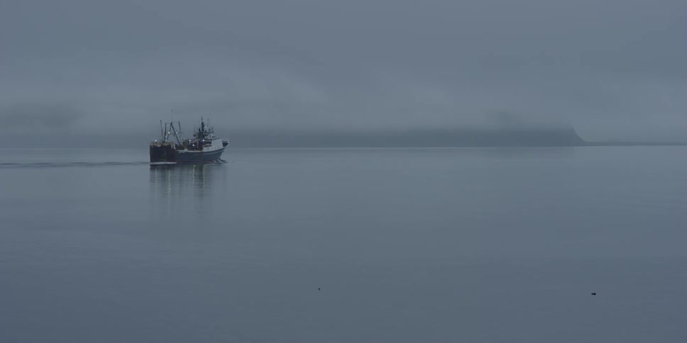 A ship is moving across calm seas
