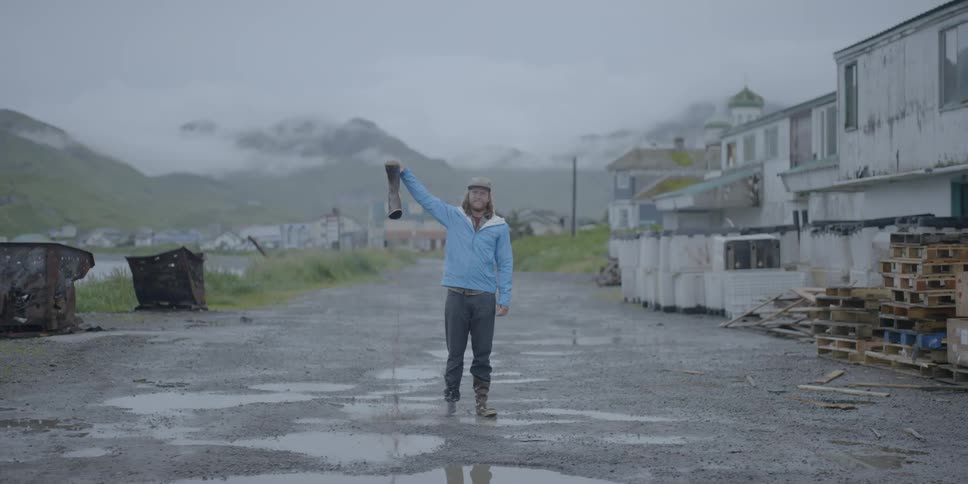 A man dumps water out of a boot