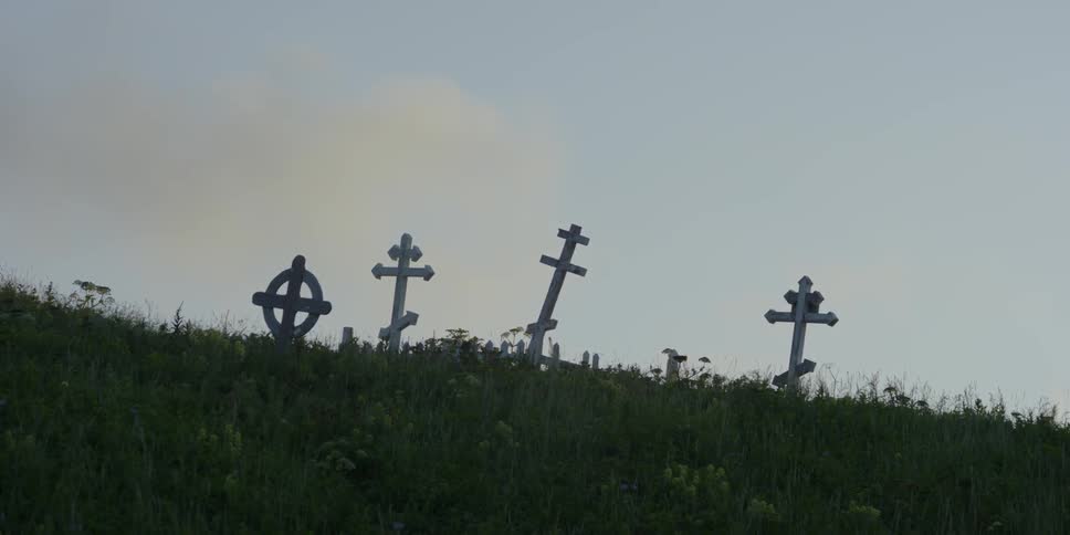 Grave markers on a grassy hill