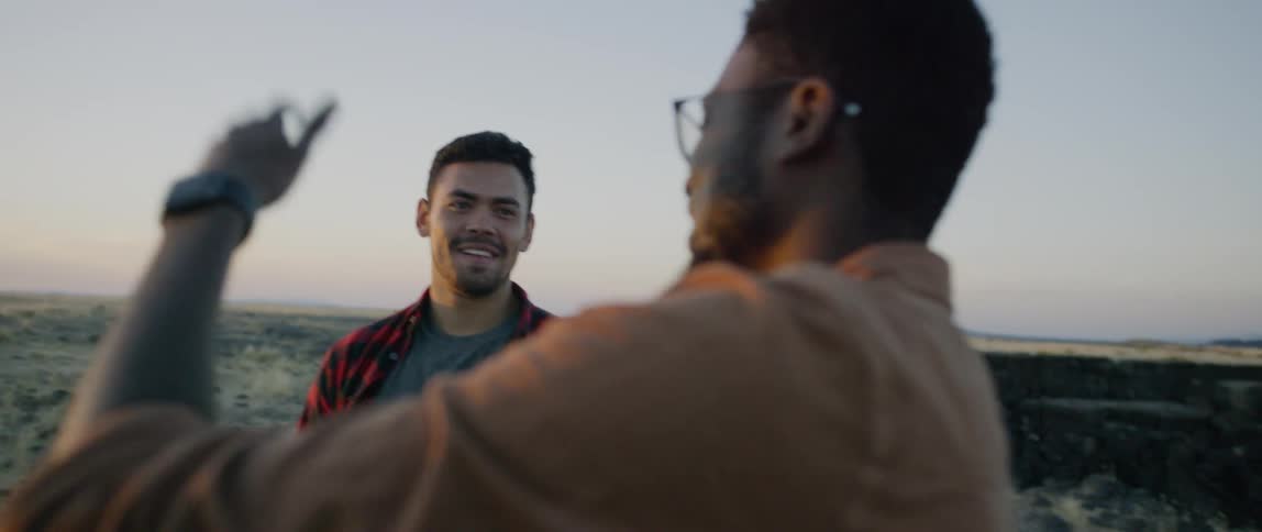 Two men have a conversation outside