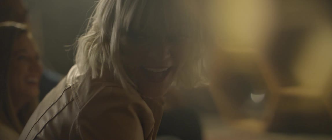 A woman laughs and leans forward