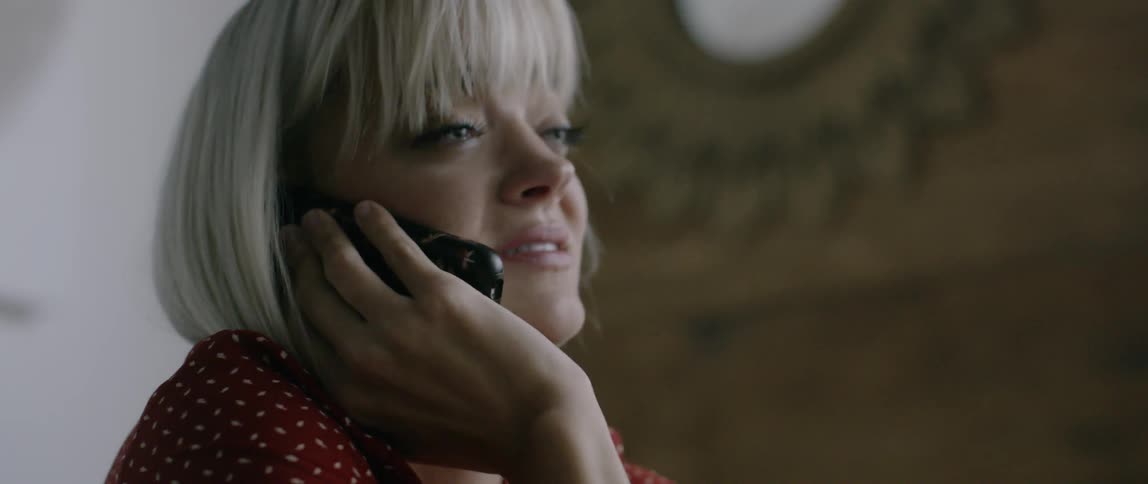 A woman cries while talking on the phone