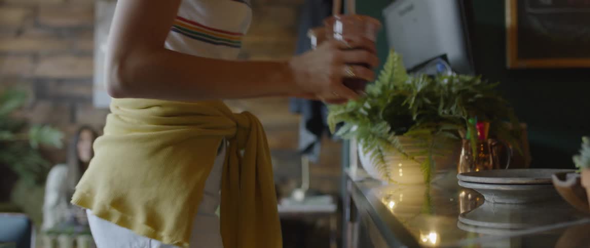 A woman serves smoothies at a restaurant