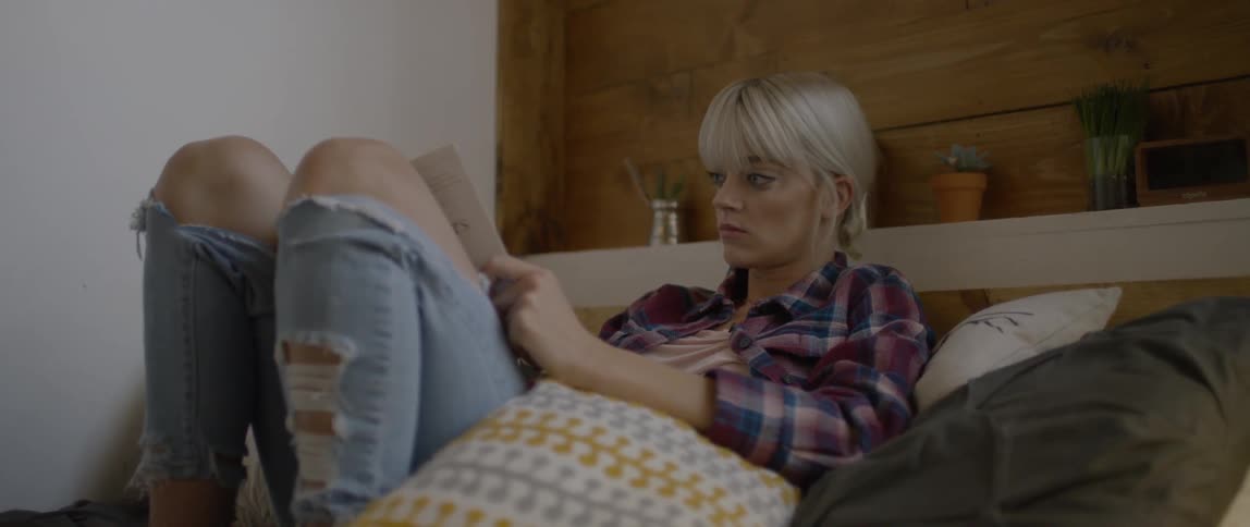 A woman reads in bed
