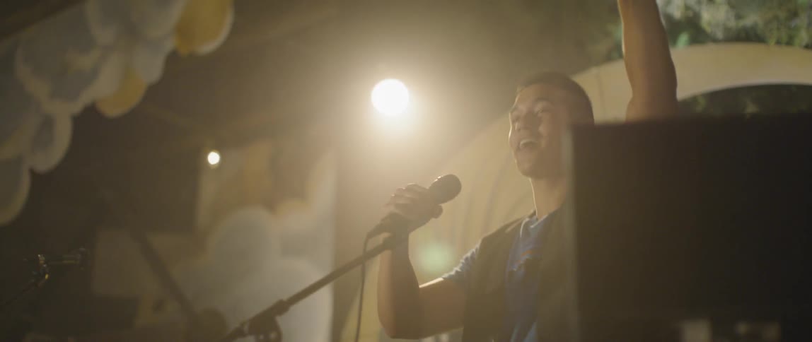 A man sings into the microphone