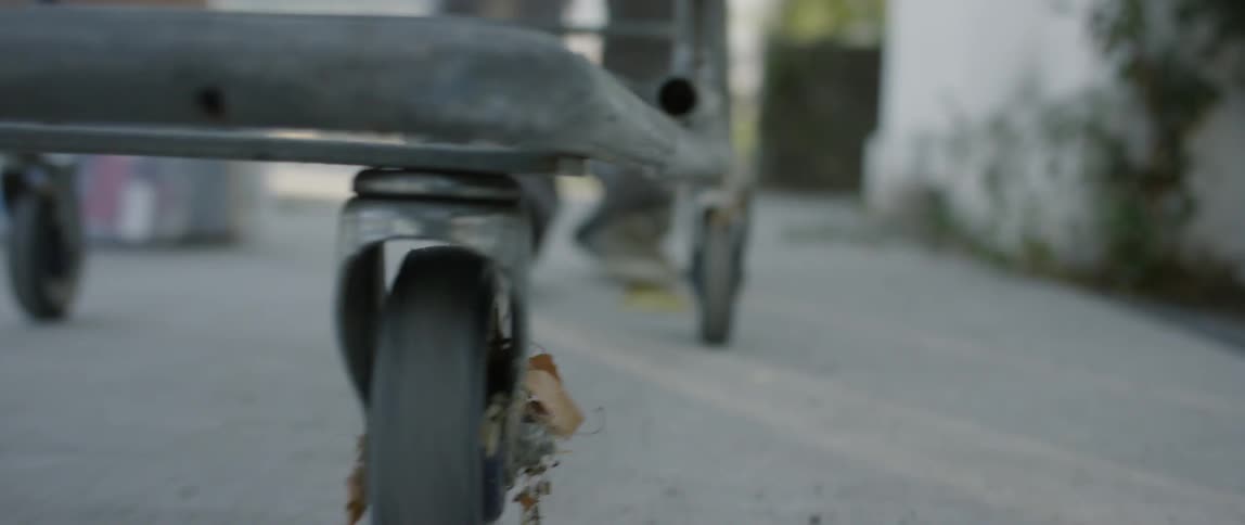 A cart is being pushed down the alley
