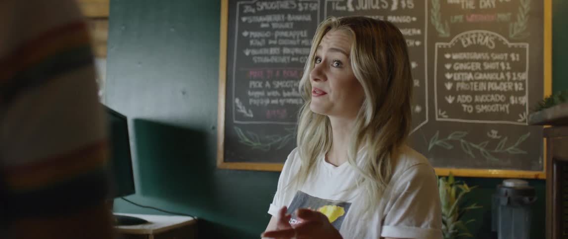 A cashier takes an order at a smoothie bar